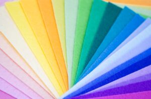 Close-up of felt fabric sheets stacked on top of each other in the colors of the rainbow spectrum