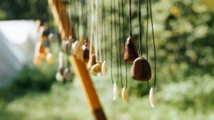 Craft handmade wooden jewelry decorations hanging outdoors. Sale of rustic ancient amulets.