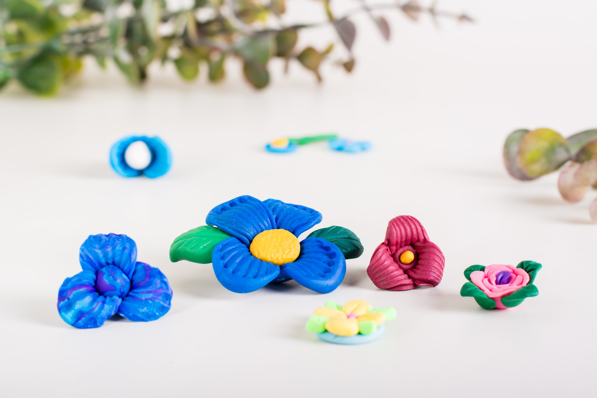 Flowers from polymer clay on a light background. Handmade decor