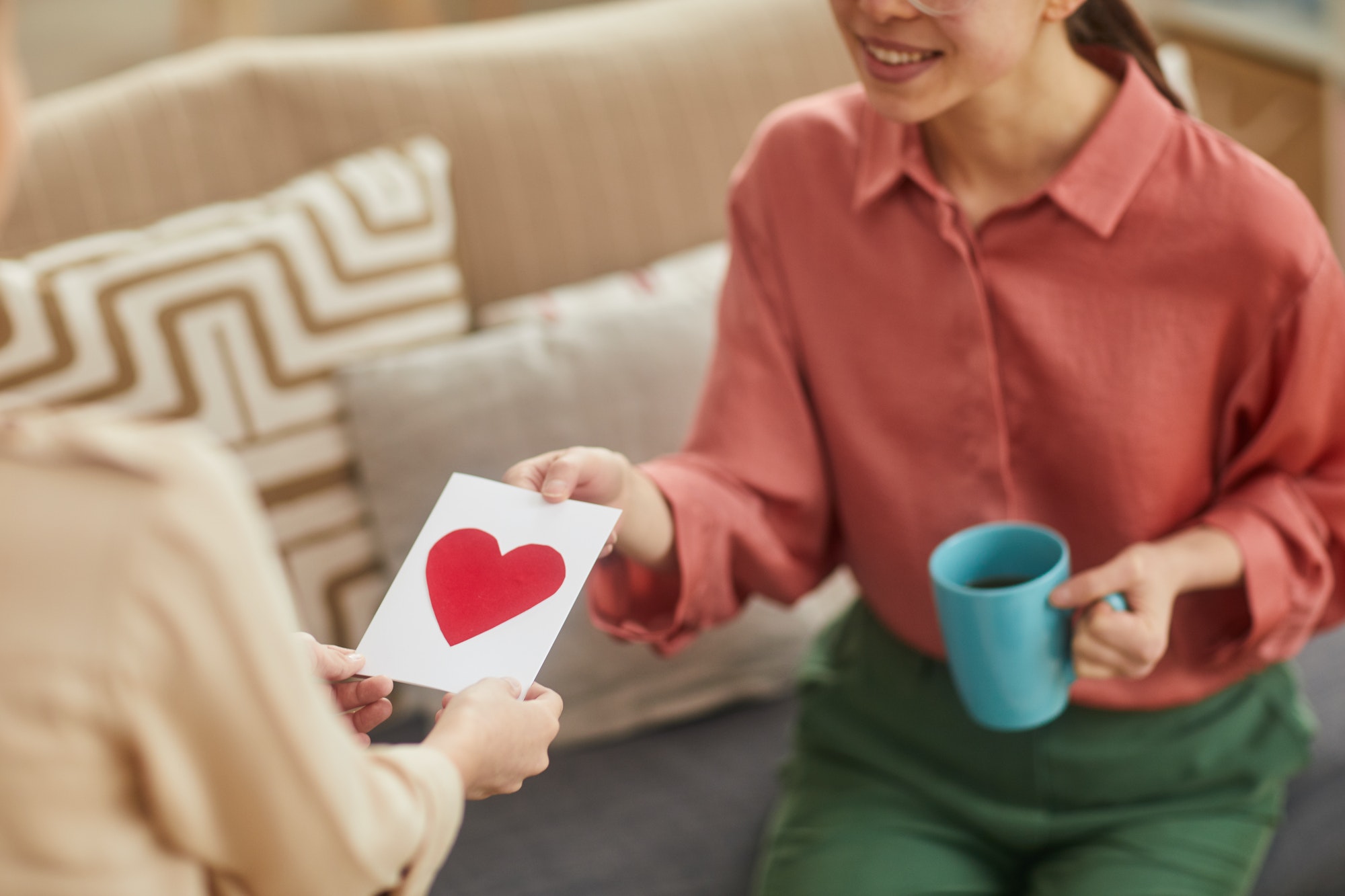 Giving Holiday Card To Mother