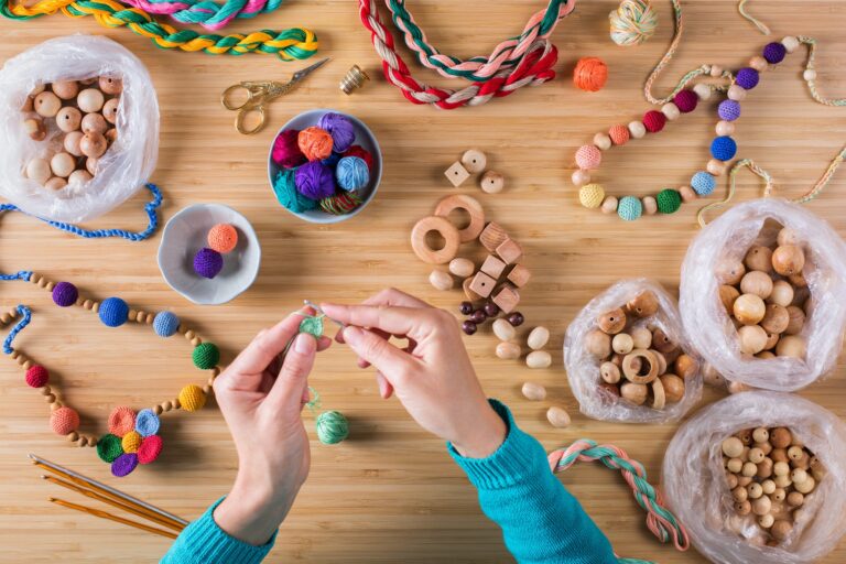 Hobby, crafting, creativity, time at home. Hands making baby beads